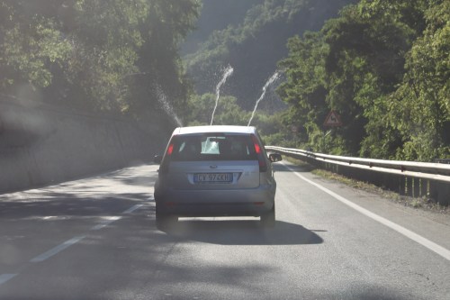 Swiss car shooting windshield washer fluid over car